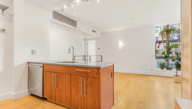 Modern kitchen island with wood cabinets.