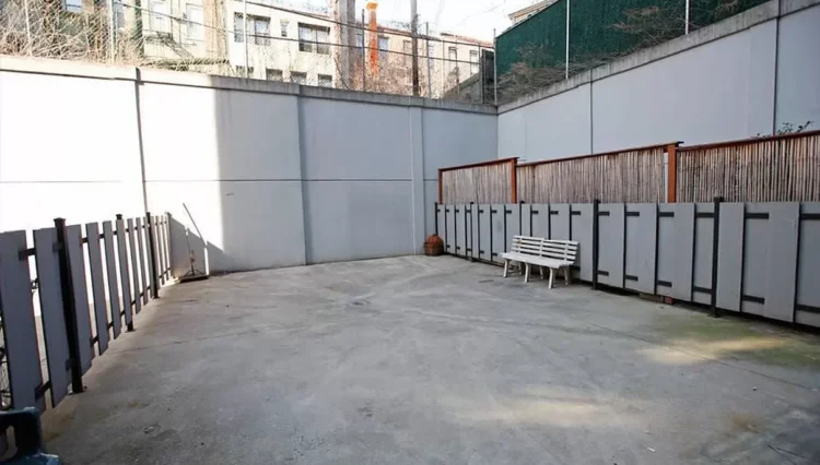 Empty concrete courtyard with a bench.