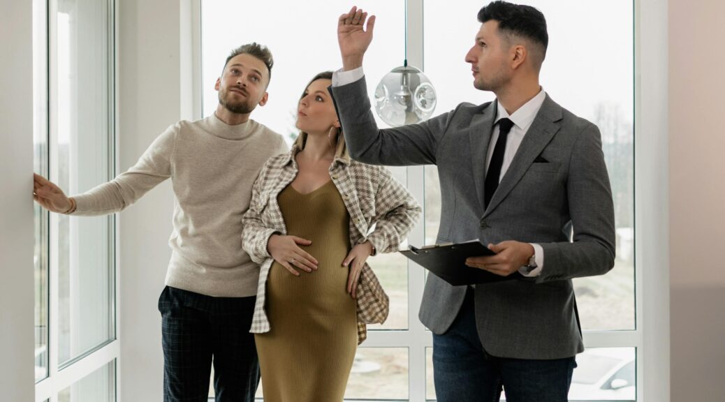 Couple and realtor viewing new home.