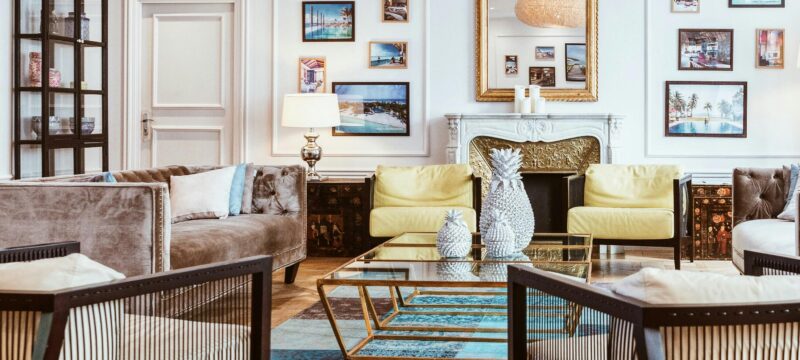 Living room with wooden floors, furniture, and artwork.