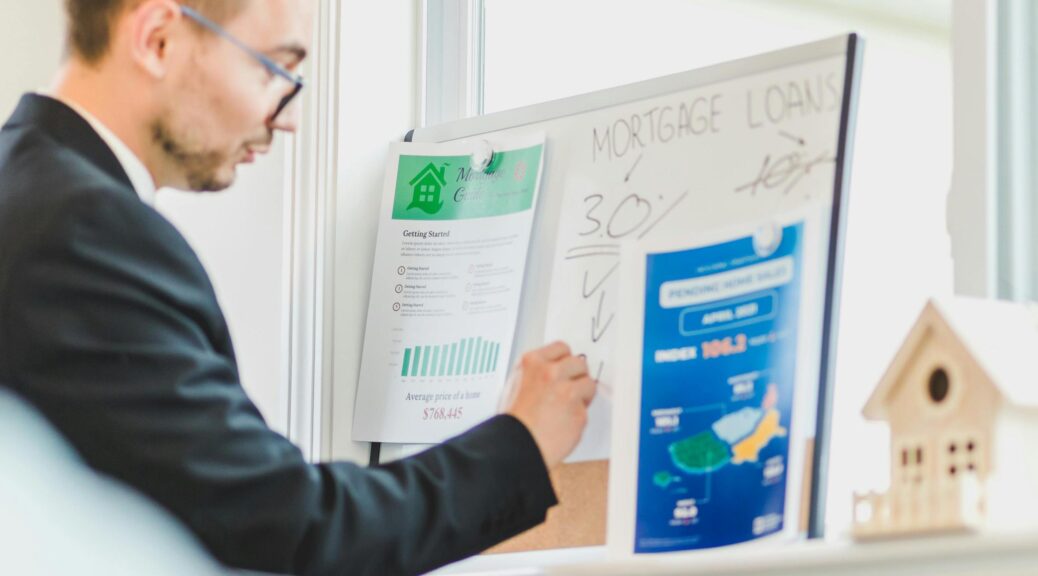 Man writing on whiteboard about mortgage loans.