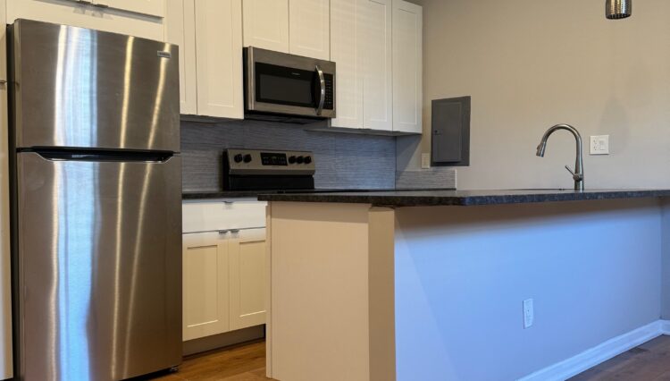 Modern kitchen with stainless steel appliances.