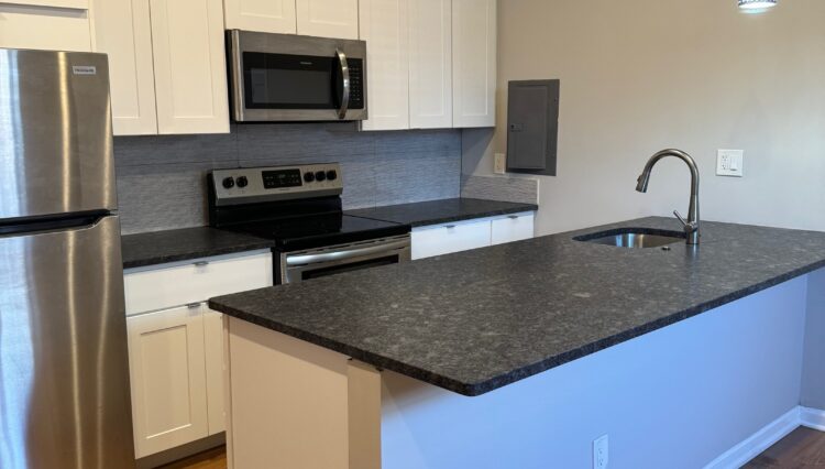 Modern kitchen with stainless steel appliances.